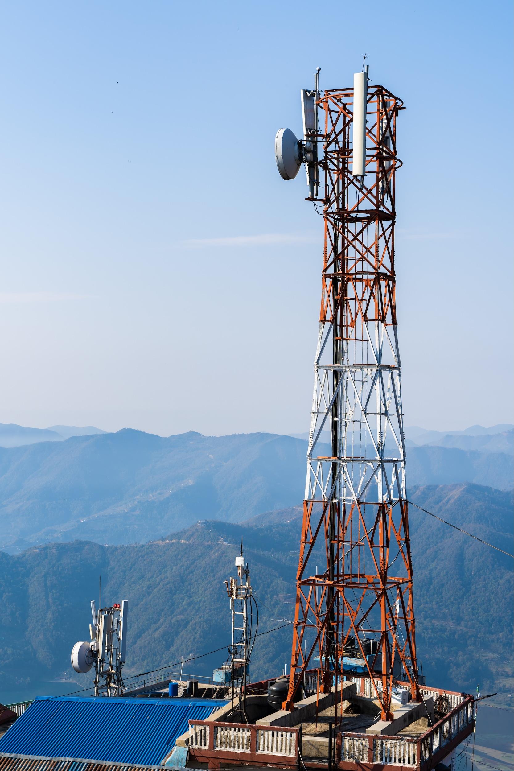 Telecommunication tower with mountains in the background