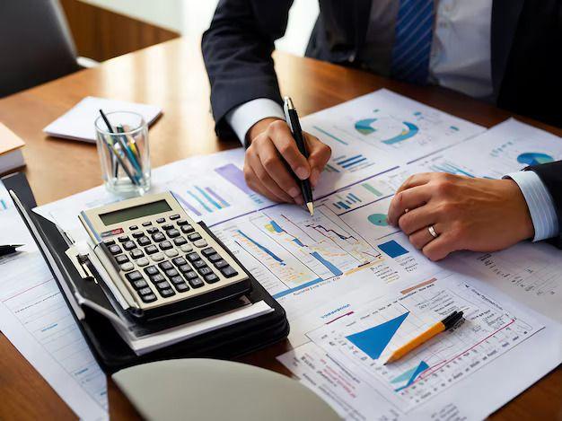 Financial advisor reviewing charts with a calculator